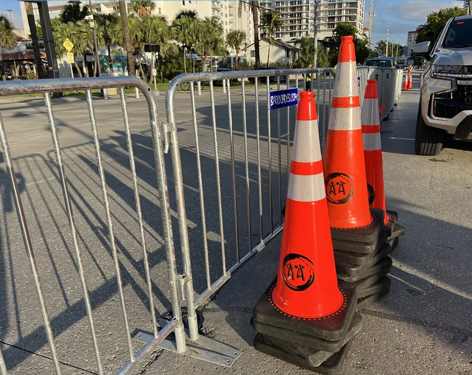 Course barricades and a mile banner going up under streetlights the night before a marathon.