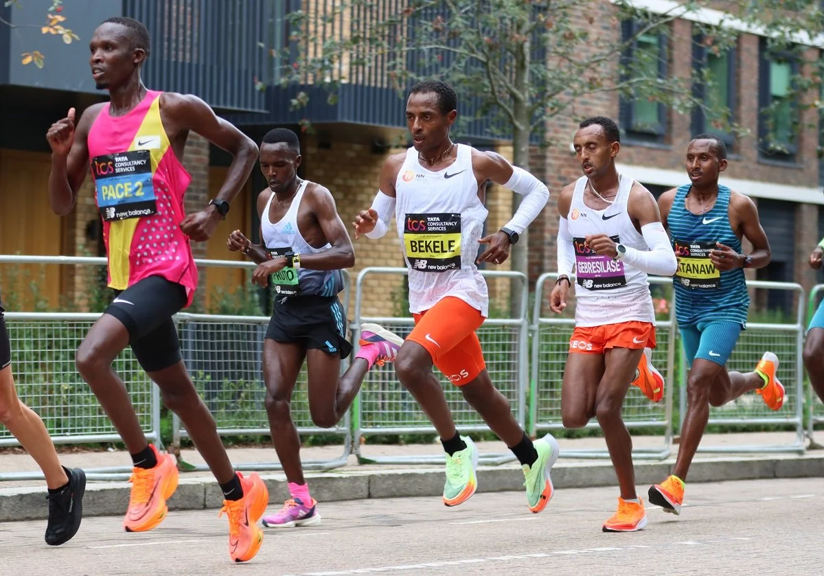An elite marathon pack mid-race, the leaders tightly grouped.