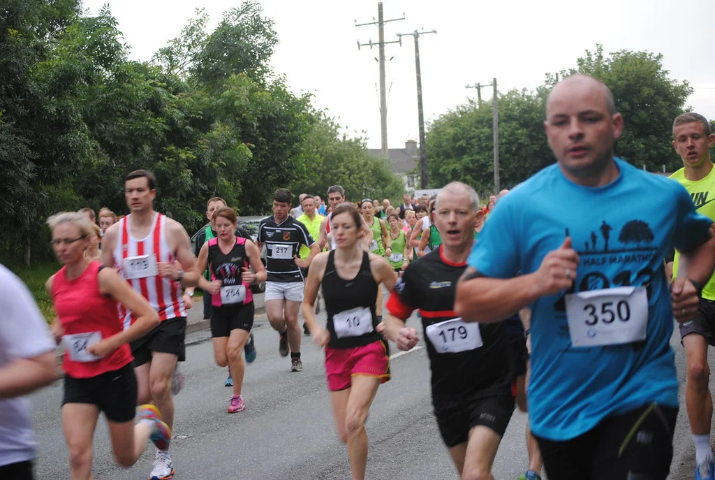 A new pair of running shoes laced beside an open front door at sunrise, ready for a first run.