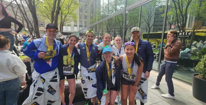 Bandit Racing Crew members in finisher jackets after the Boston Marathon