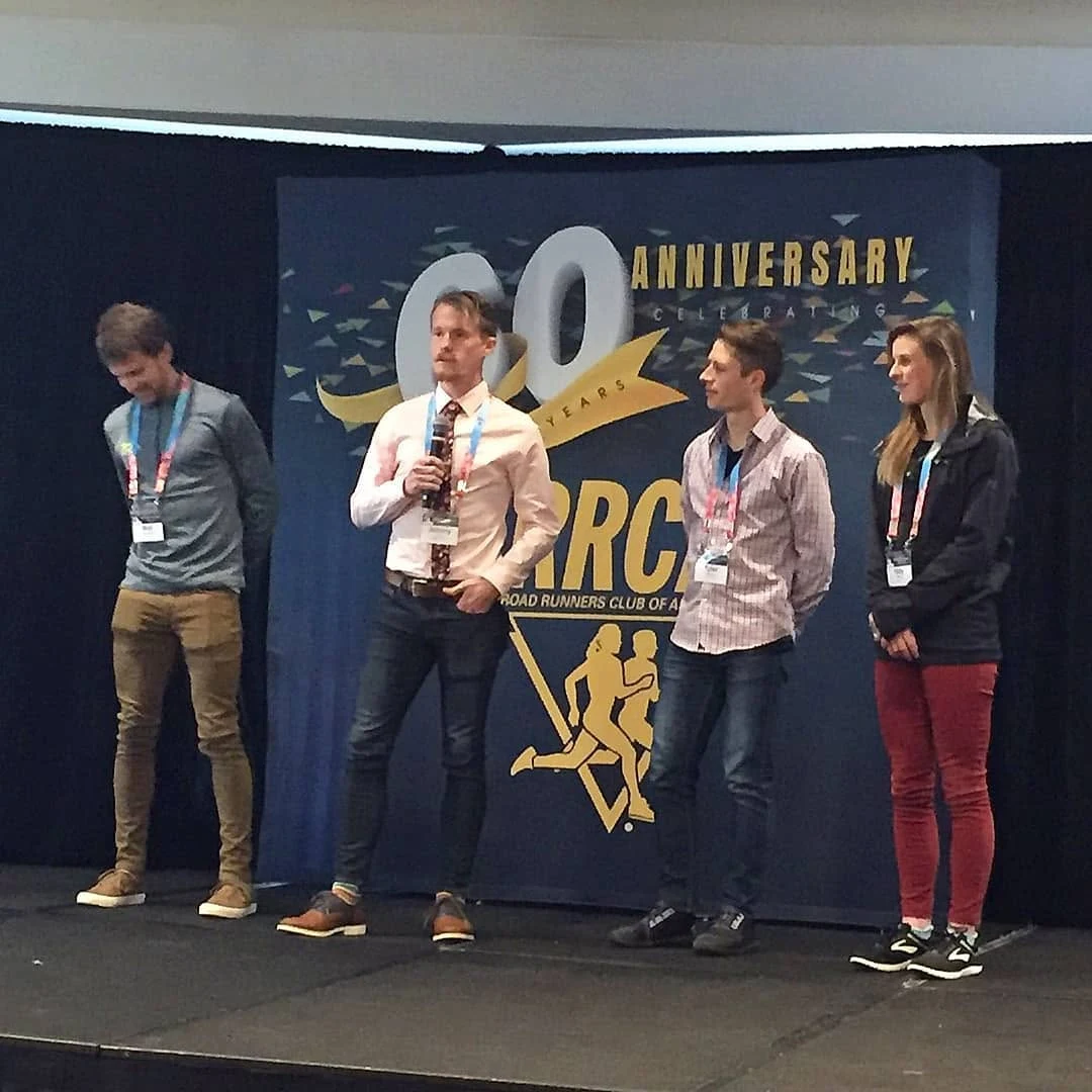 Johnny Crain speaking on stage at the RRCA National Convention 60th anniversary celebration