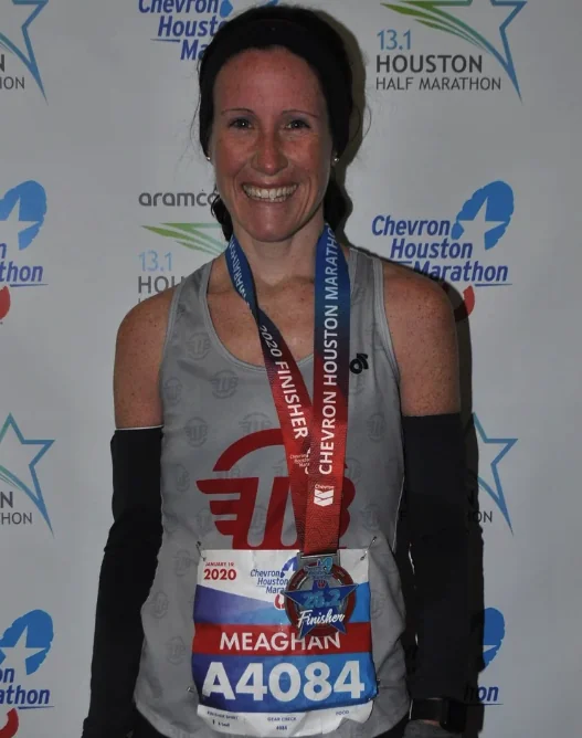 Meg with her Houston Marathon finisher medal