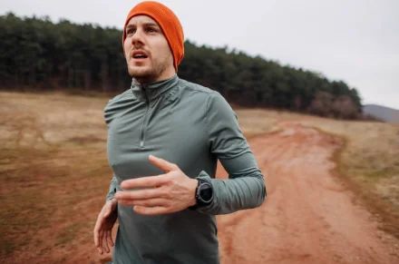 Marcus on a cold morning trail run in an orange beanie