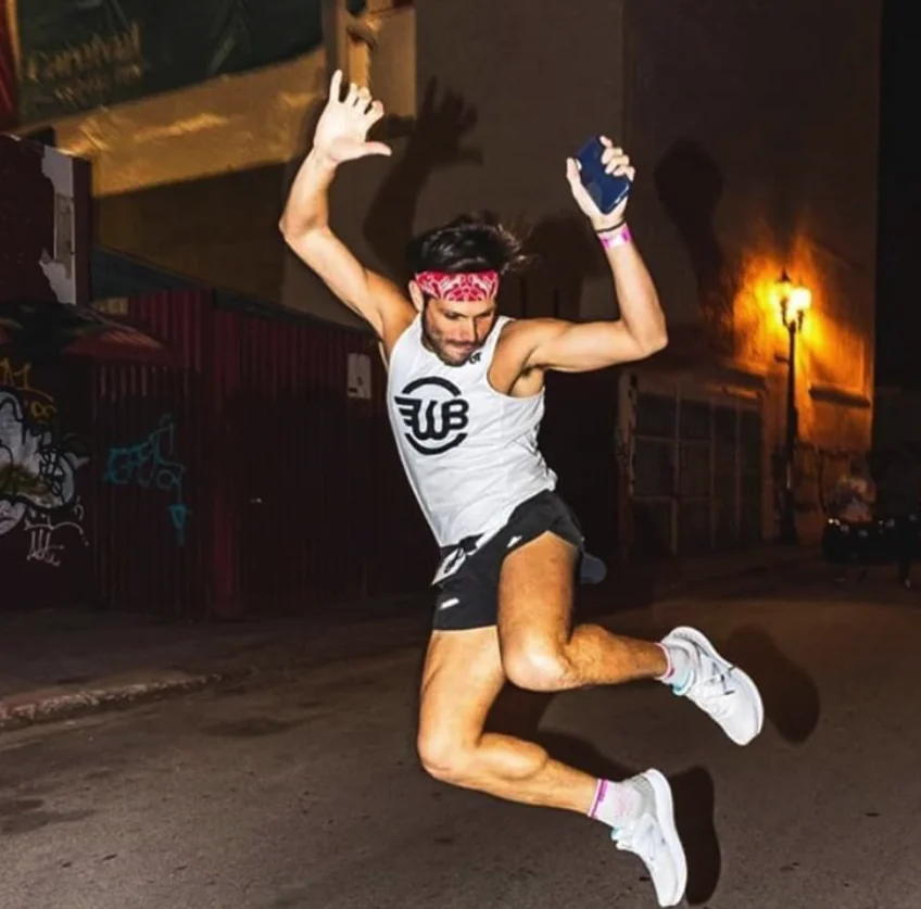 A RunFitCoach athlete celebrating a personal record at the Miami 70.3 triathlon.
