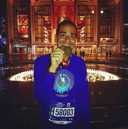 A New York City Marathon finisher medal photographed at Lincoln Center.