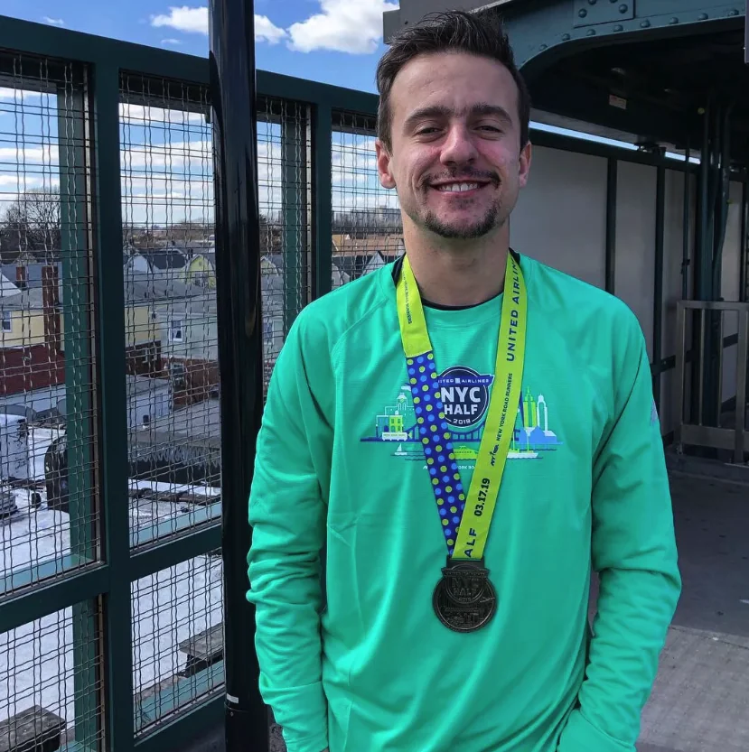 Devin wearing his NYC Half Marathon finisher medal.