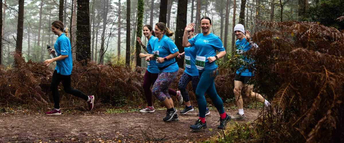 Jenna training with her women's run club in the woods